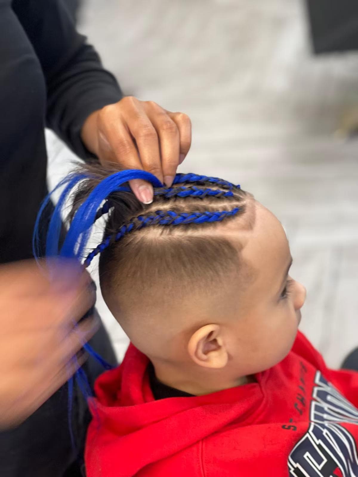 Tamara braiding blue extension braids in progress at Hair Talks Rouse Hill